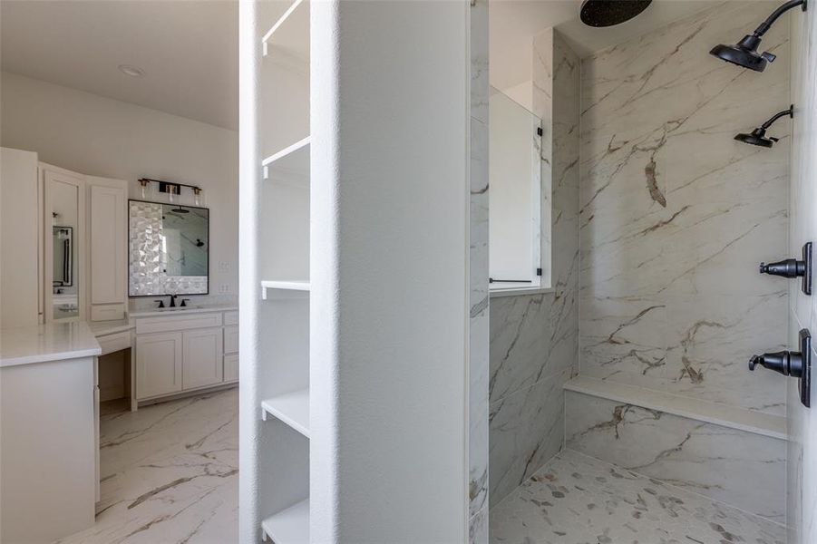 Bathroom with a tile shower and vanity