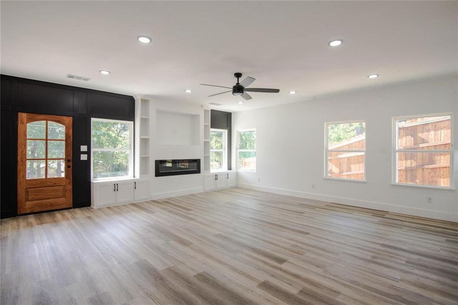 Unfurnished living room with light hardwood / wood-style flooring and ceiling fan