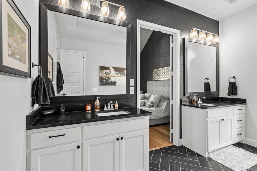 Bathroom featuring tile flooring and double sink vanity