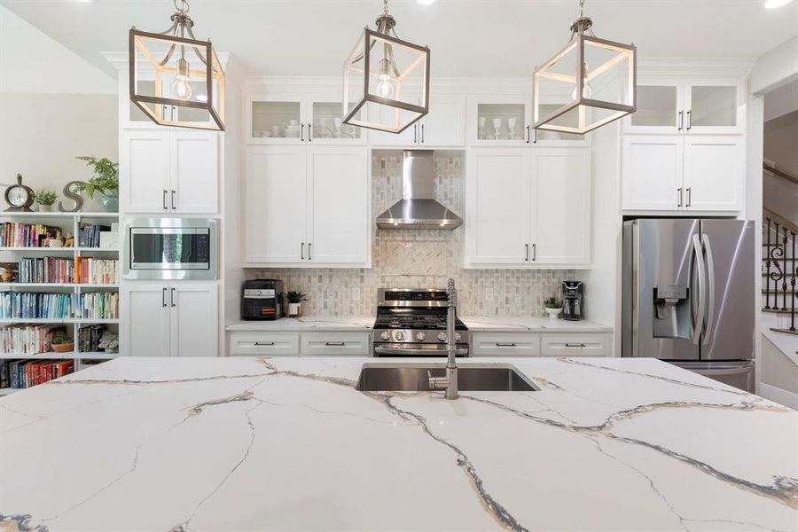 Custom quartz countertops with veining capture everyone's attention when they walk in.