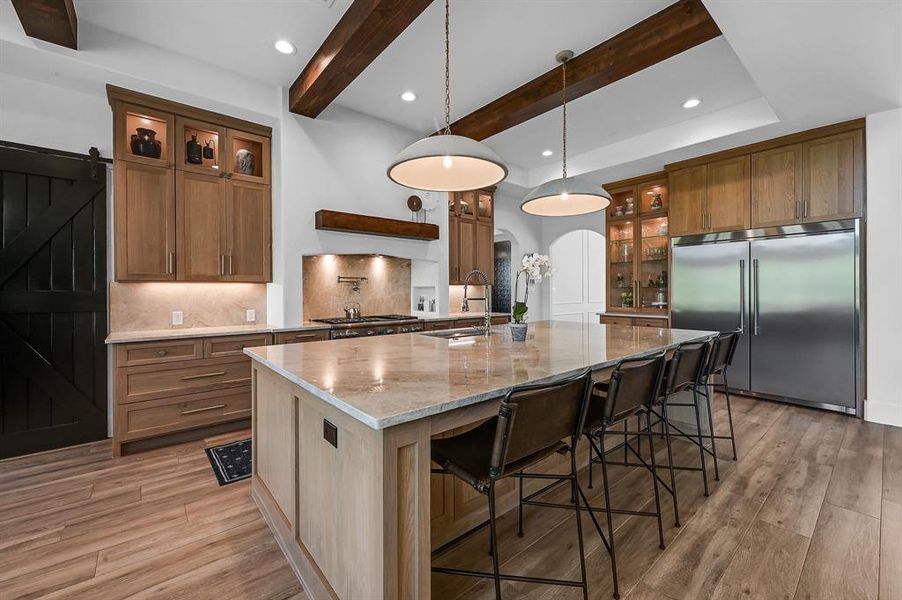 Gourmet kitchen with convenient pot filler and elegant quartzite backsplash, perfect for culinary enthusiasts.