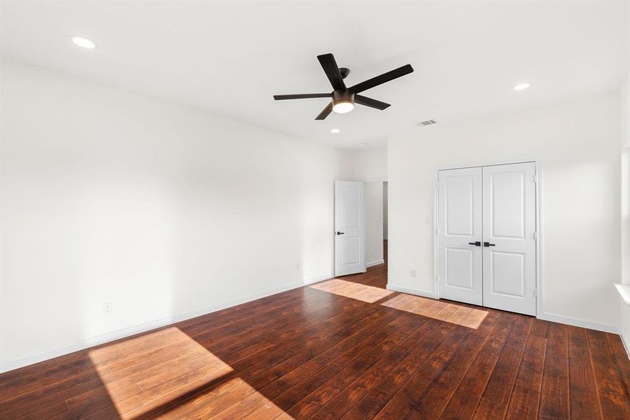 Unfurnished bedroom with hardwood / wood-style flooring, a closet, and ceiling fan