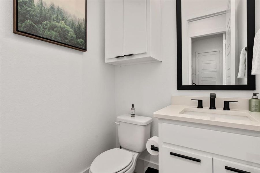 powder room featuring oversized vanity and toilet