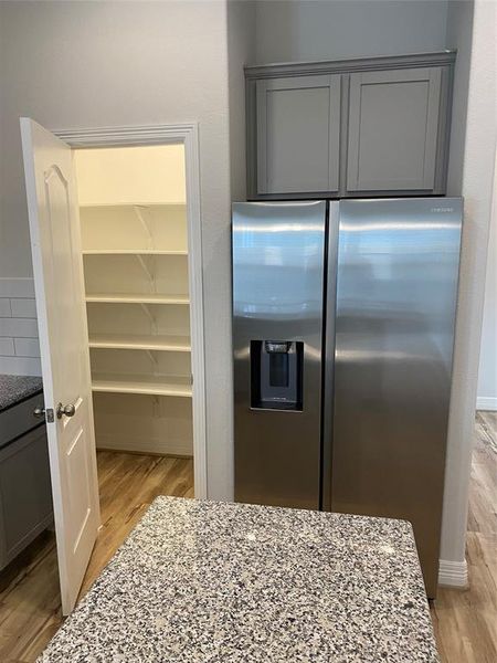 Walk in lighted kitchen pantry. Storage above the fridge.