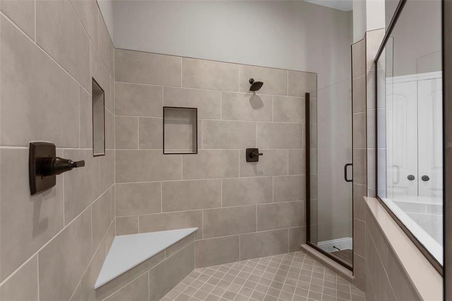 Bathroom featuring tile patterned floors and a shower with shower door