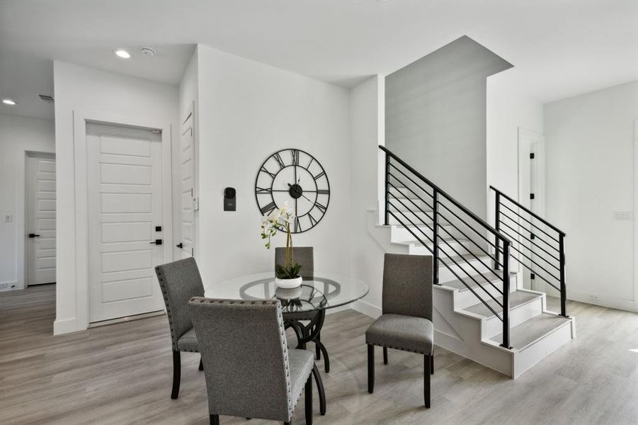 Dining space with light hardwood / wood-style floors