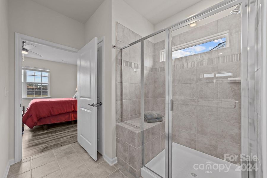 Primary bath shower area with clerestory window for natural light and privacy.