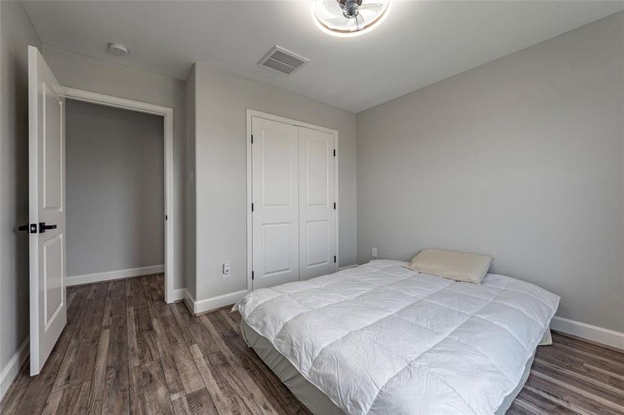 A charming secondary bedroom with generous closet space and large windows