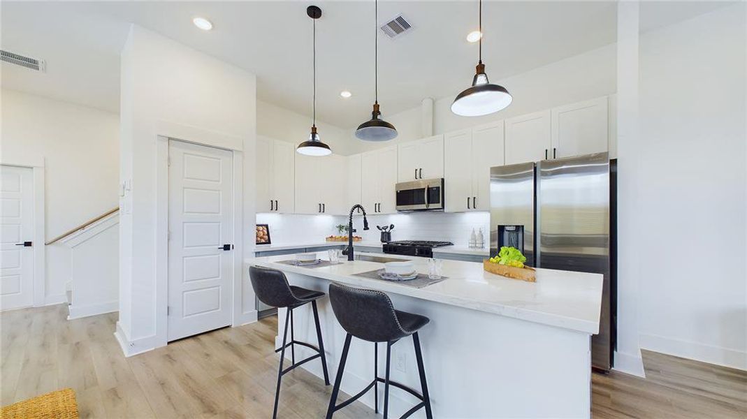 A large kitchen island is perfect for gatherings and food preparation.