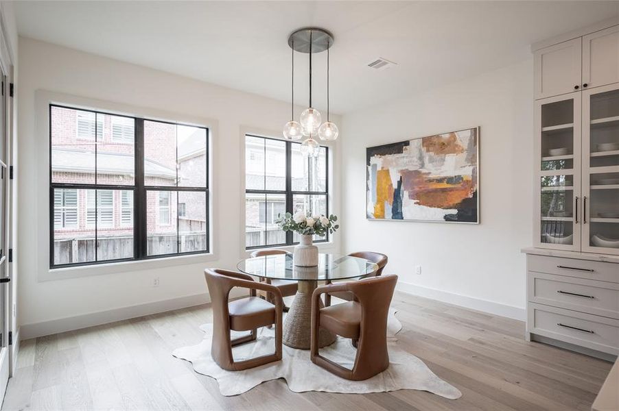 Versatile space off the kitchen perfect as a breakfast nook or formal dining area, with easy access to the covered patio through the adjacent door.