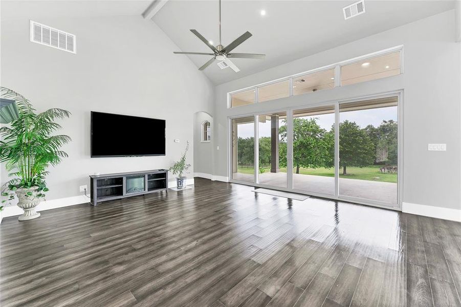 Living room with high ceilings and sliding glass doors