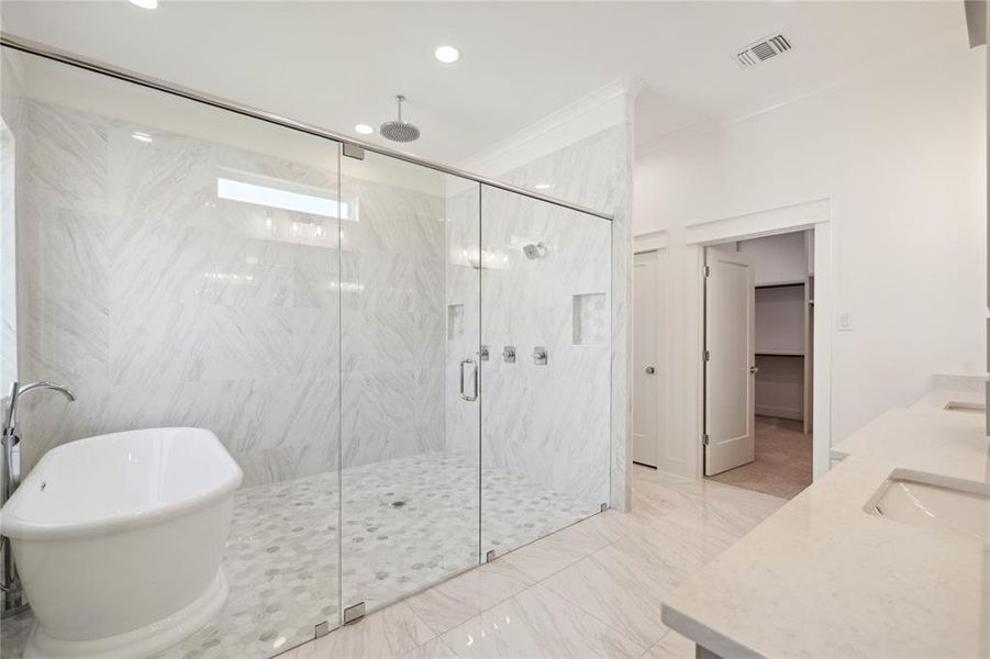 Bathroom featuring sink and separate shower and tub