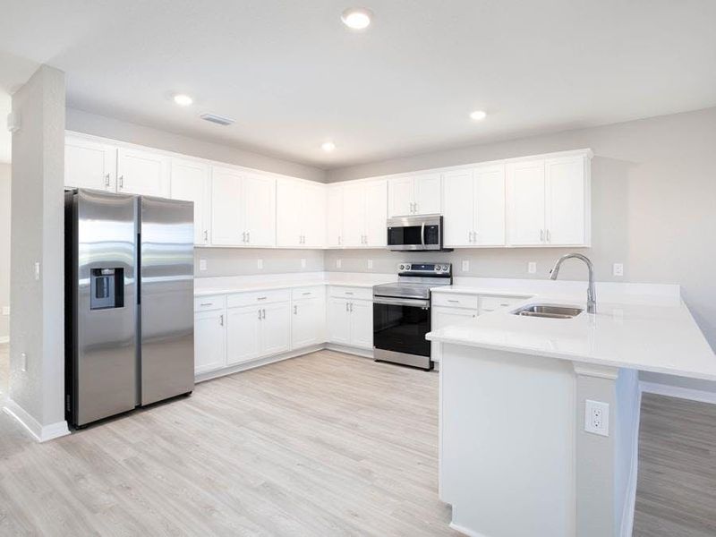 The sunny and spacious kitchen with pantry is the heart of the home - Wayfair II home plan by Highland Homes