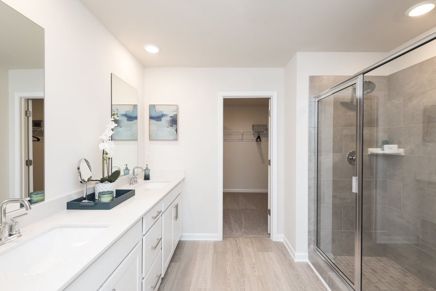 The private suite boasts a walk-in shower and dual-vanity sinks.