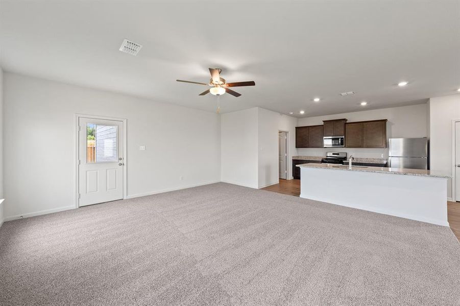 Living room featuring light wood-style flooring and ceiling fan