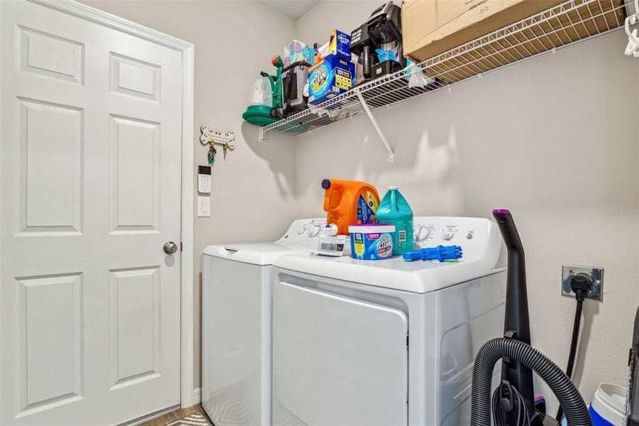 Inside laundry room with washer/dryer staying