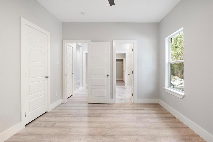 Unfurnished bedroom featuring ceiling fan and light hardwood / wood-style flooring