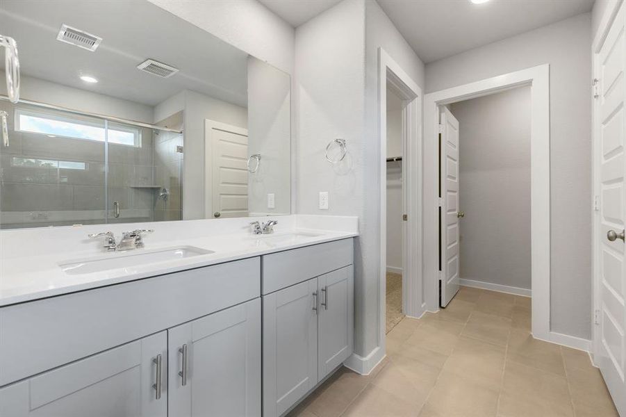 This primary bathroom is definitely move-in ready! Featuring a spa-like oversized walk-in shower with tile surround, Quartz countertops, spacious walk-in closet with shelving, high ceilings, neutral paint, sleek and modern finishes.