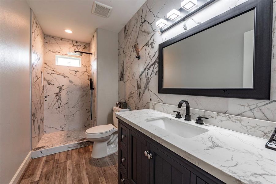 All three full baths are adorned with luxurious marble tile walk-in showers and dual vanities featuring LED lighting. Experience spa-like relaxation and elegance in every bathroom!