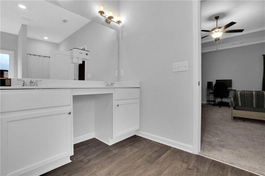 Bathroom featuring ceiling fan, vanity, and hardwood / wood-style flooring