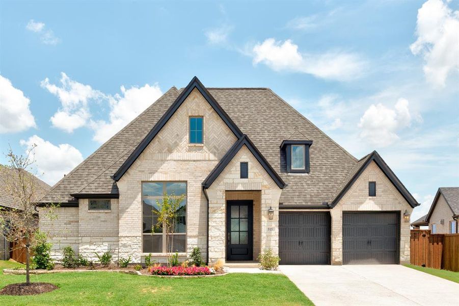 View of front of house featuring a garage and a front yard