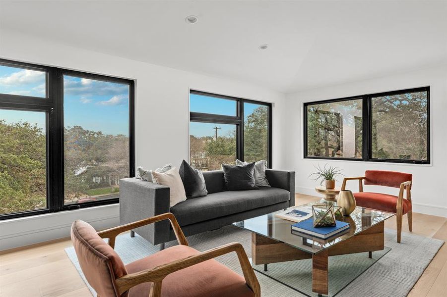The third floor boasts magnificent neighborhood and downtown views, but the operational windows also facilitate a thermal siphon effect on cooler days, pulling hot air up the open stairs and out of the home.