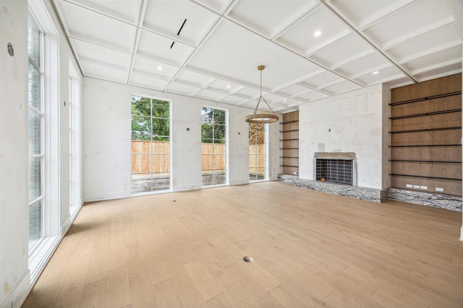 Family Room with Built-In Shelves, Gas Log/Wood Burning Fireplace with a Venetian Plaster Wall.  Construction as of November 8th, 2024.