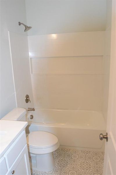 Full bathroom featuring shower / tub combination, vanity, and toilet