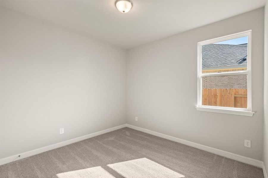 Your secondary bedroom features plush carpet, fresh paint, closet, and a large window that lets in plenty of natural lighting.