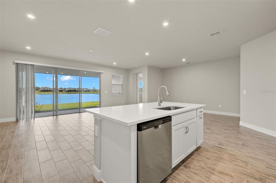 Kitchen View to Great Room and Dining - The window view may not be the same, as thie house offered for sale is on a different water lot.