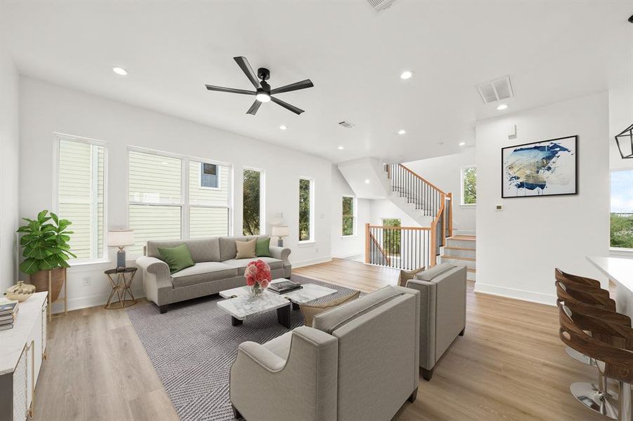 Virtually Staged: Welcome to your open living space! Complete with high ceilings, an abudance of light from many windows, recessed lights, ceiling fan, LVP floors and more.