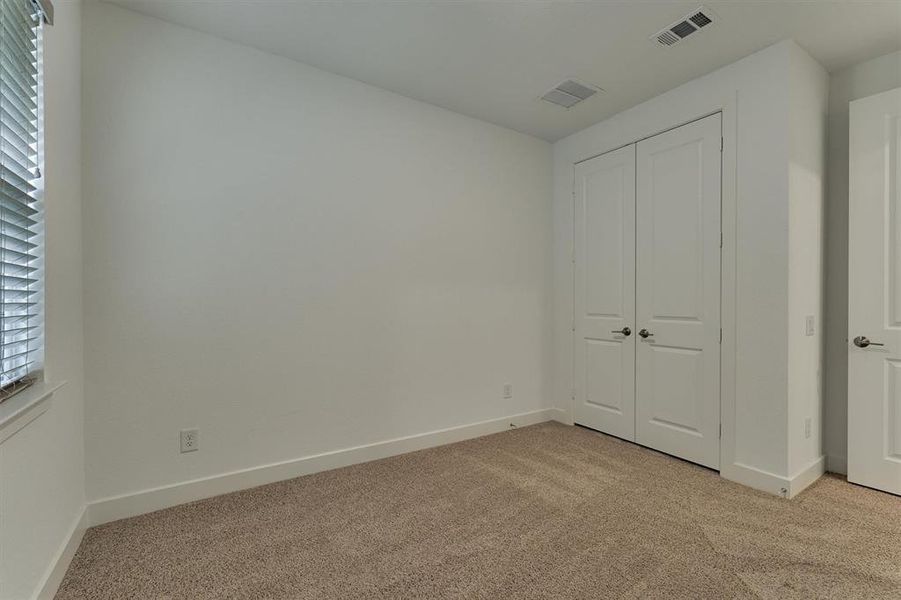 Secondary bedroom features a double door closet.