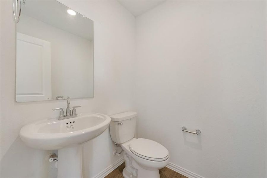 Bathroom featuring toilet and hardwood / wood-style flooring