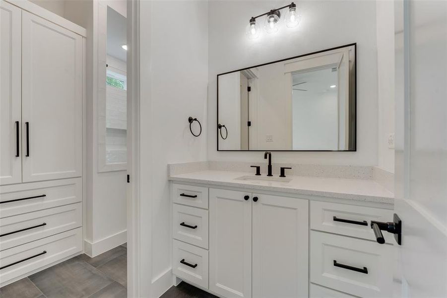 Bathroom with tile patterned floors and vanity