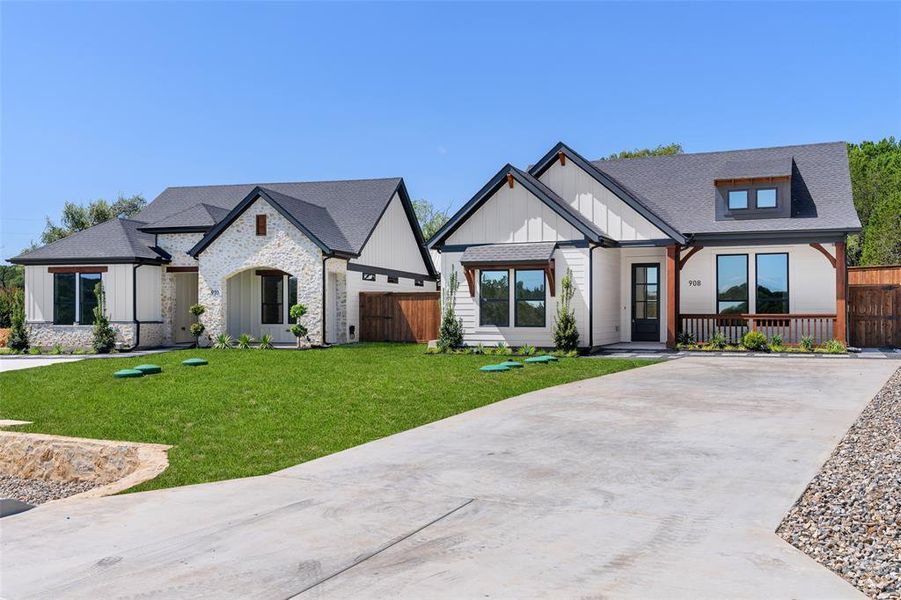 View of front of property with a front lawn and a porch