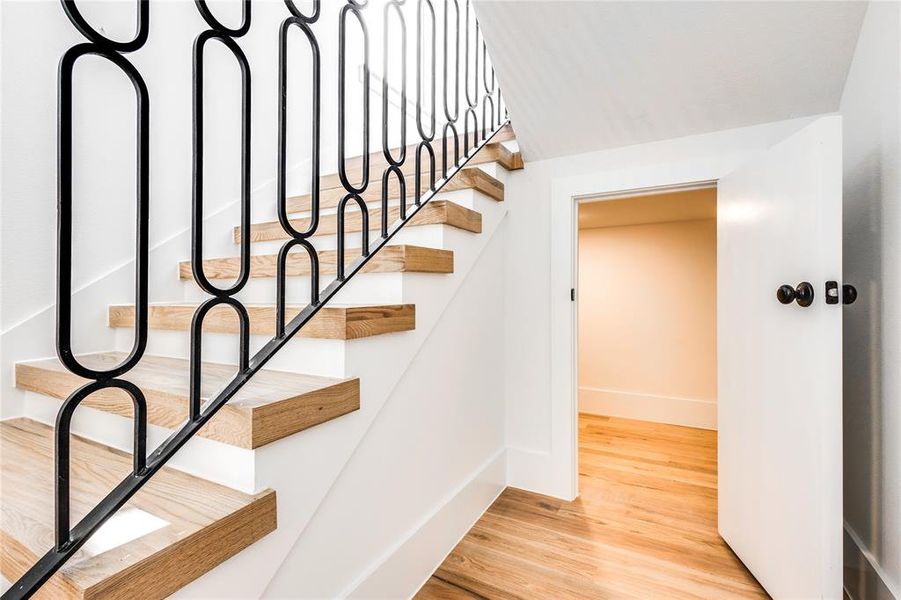 Stairway with light hardwood / wood-style floors