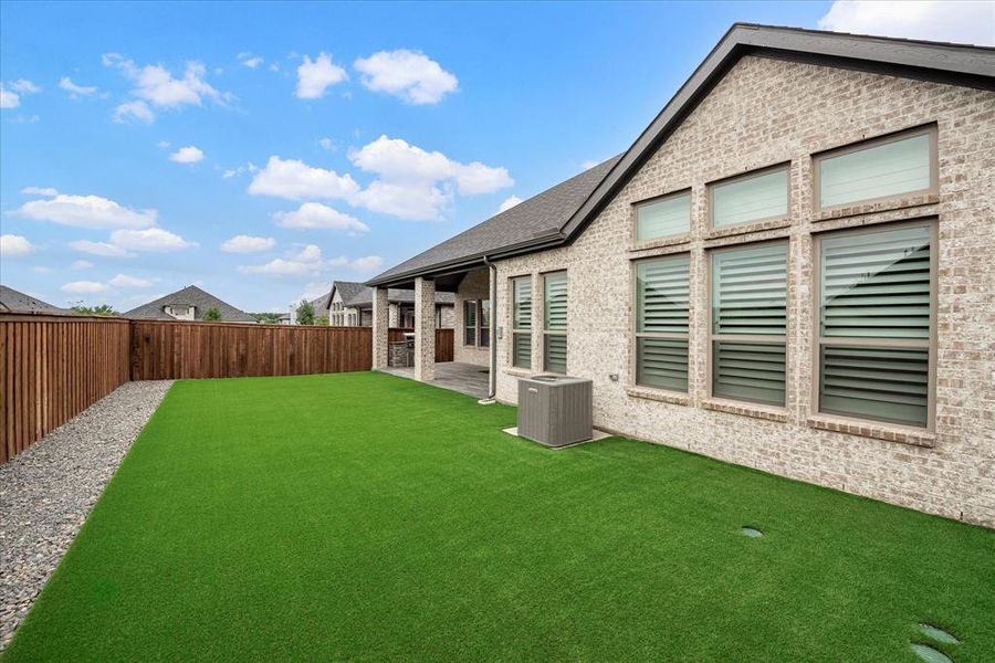 View of yard with a patio and central AC unit