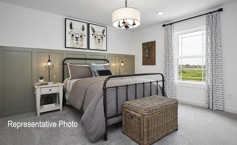 Bedroom featuring a chandelier and carpet