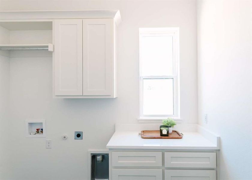 Laundry room featuring hookup for a gas dryer, washer hookup, electric dryer hookup, and cabinets