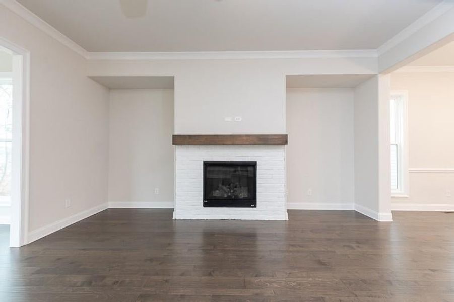 The family room, with an optional gas-burning fireplace is perfect for family gatherings.  
Photo not actual home, but previously built Mansfield plan.