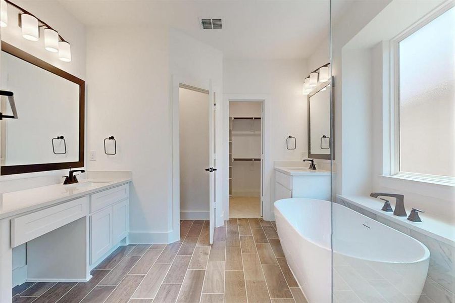 Bathroom with vanity and a bathing tub