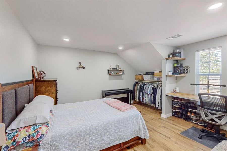 Bedroom with lofted ceiling