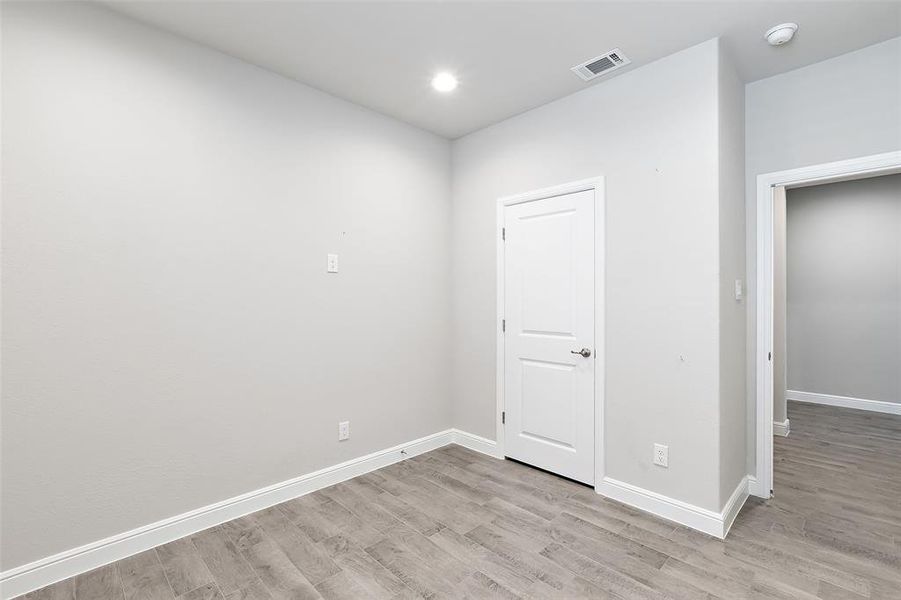 Empty room with light hardwood / wood-style floors