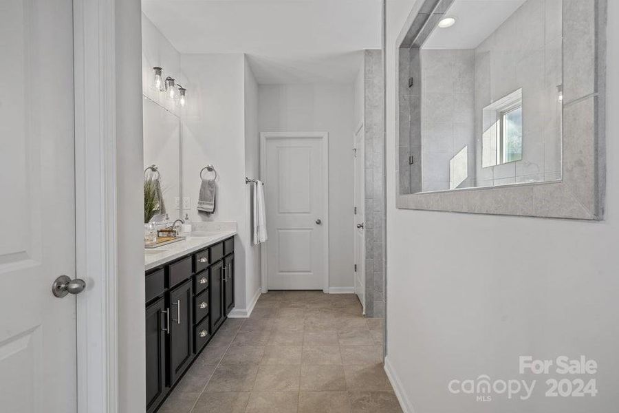 PHOTO REPRESENTATION ONLY. Primary bathroom of decorated model home. Finishes are different than shown. Refer to interior design selections for finishes.