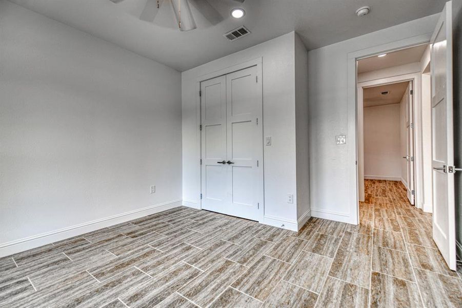 Unfurnished bedroom featuring a closet and ceiling fan