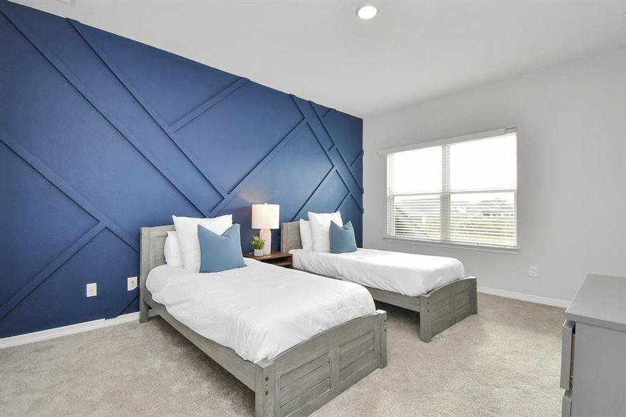 The fifth bedroom features plushcarpet, large windows, and customaccent wall.