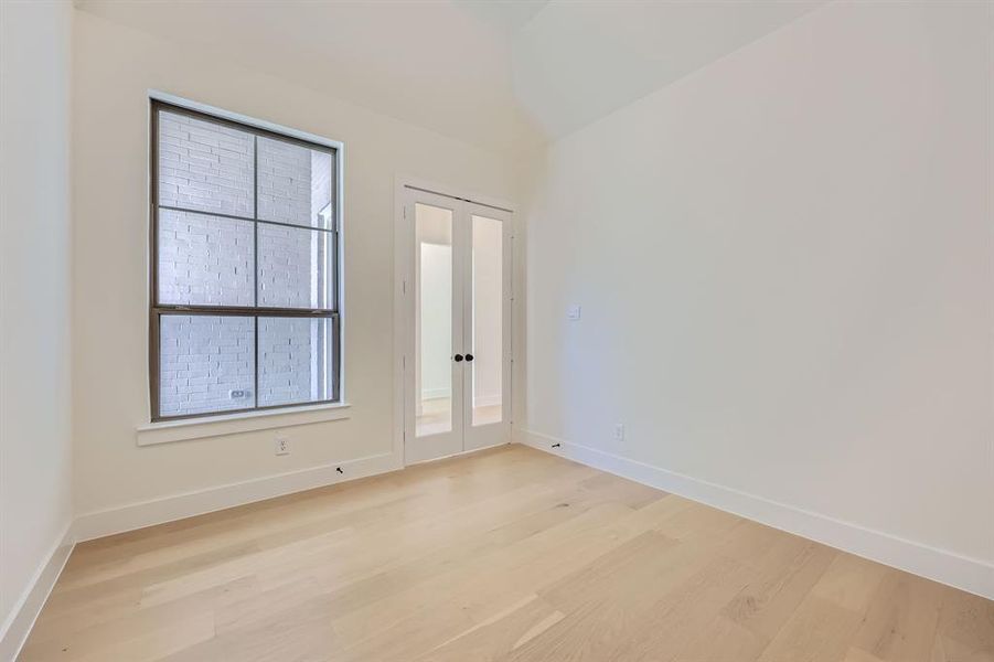 Empty room with light hardwood / wood-style flooring