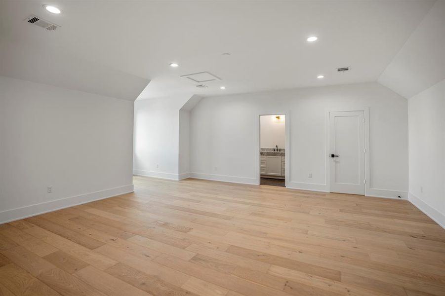 A reverse view of this large room. Closed door is a walk-in closet.
