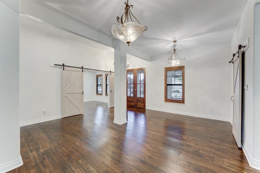 The dark hardwood floors compliment the white walls and wood-framed windows in this light-filled space.