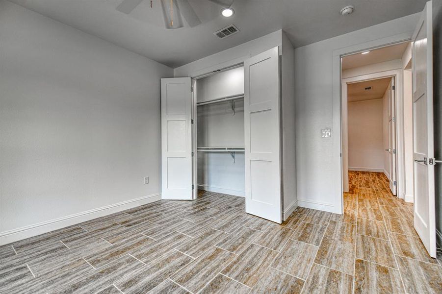 Unfurnished bedroom featuring a closet and ceiling fan